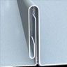 Close-up of interlocking metal siding with a white finish.