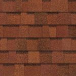 Brown asphalt roofing shingles, textured surface.