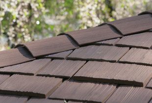 Close-up of brown wood shingle roof, angled view.