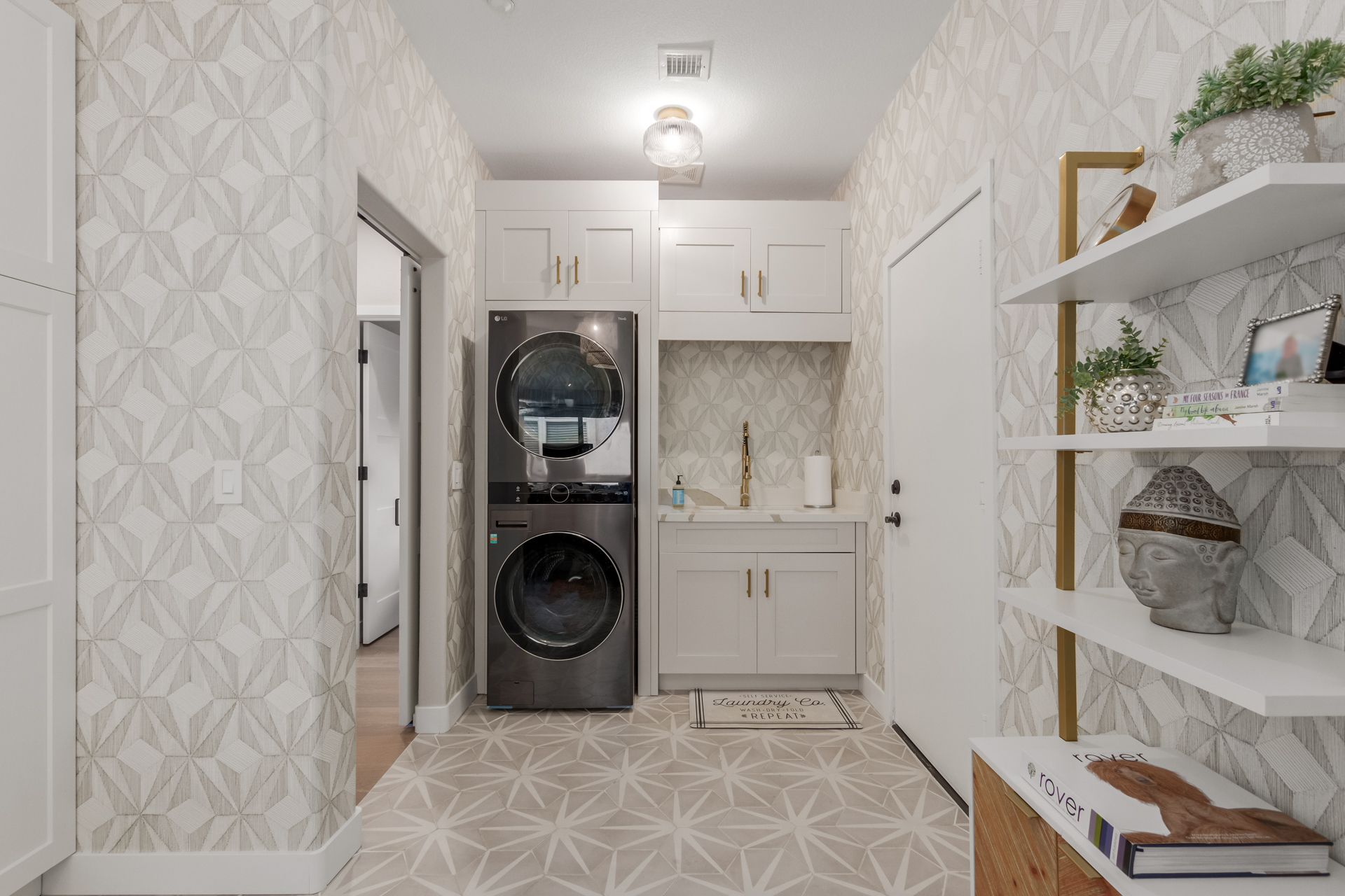 A laundry room with a washer and dryer stacked on top of each other.