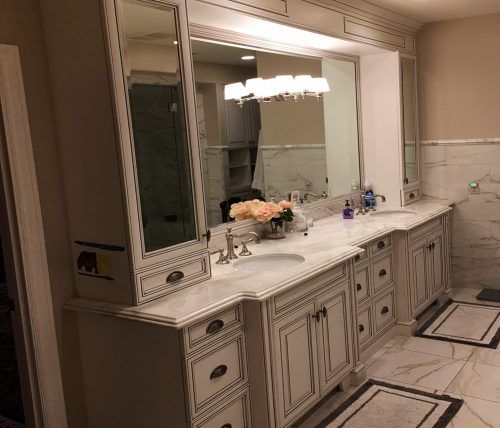 A bathroom with two sinks and a large mirror.