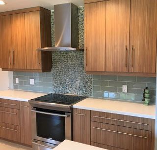 A kitchen with wooden cabinets , a stove , and a hood.