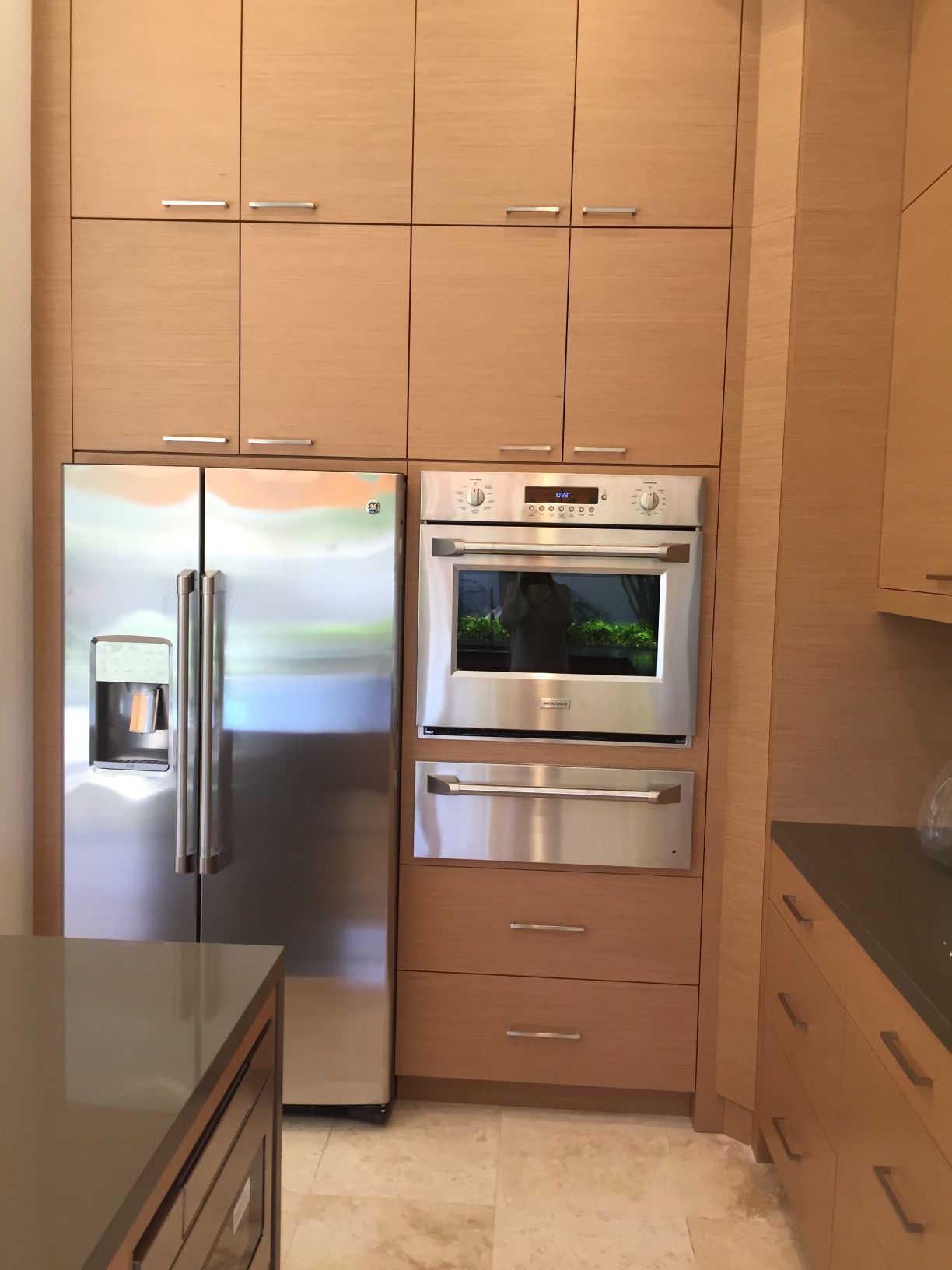 A kitchen with stainless steel appliances and wooden cabinets