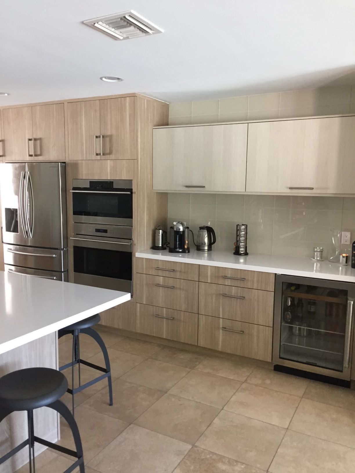 A kitchen with wooden cabinets and stainless steel appliances