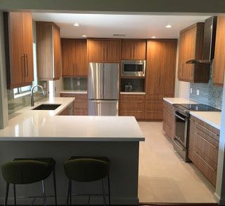 A kitchen with stainless steel appliances and wooden cabinets.