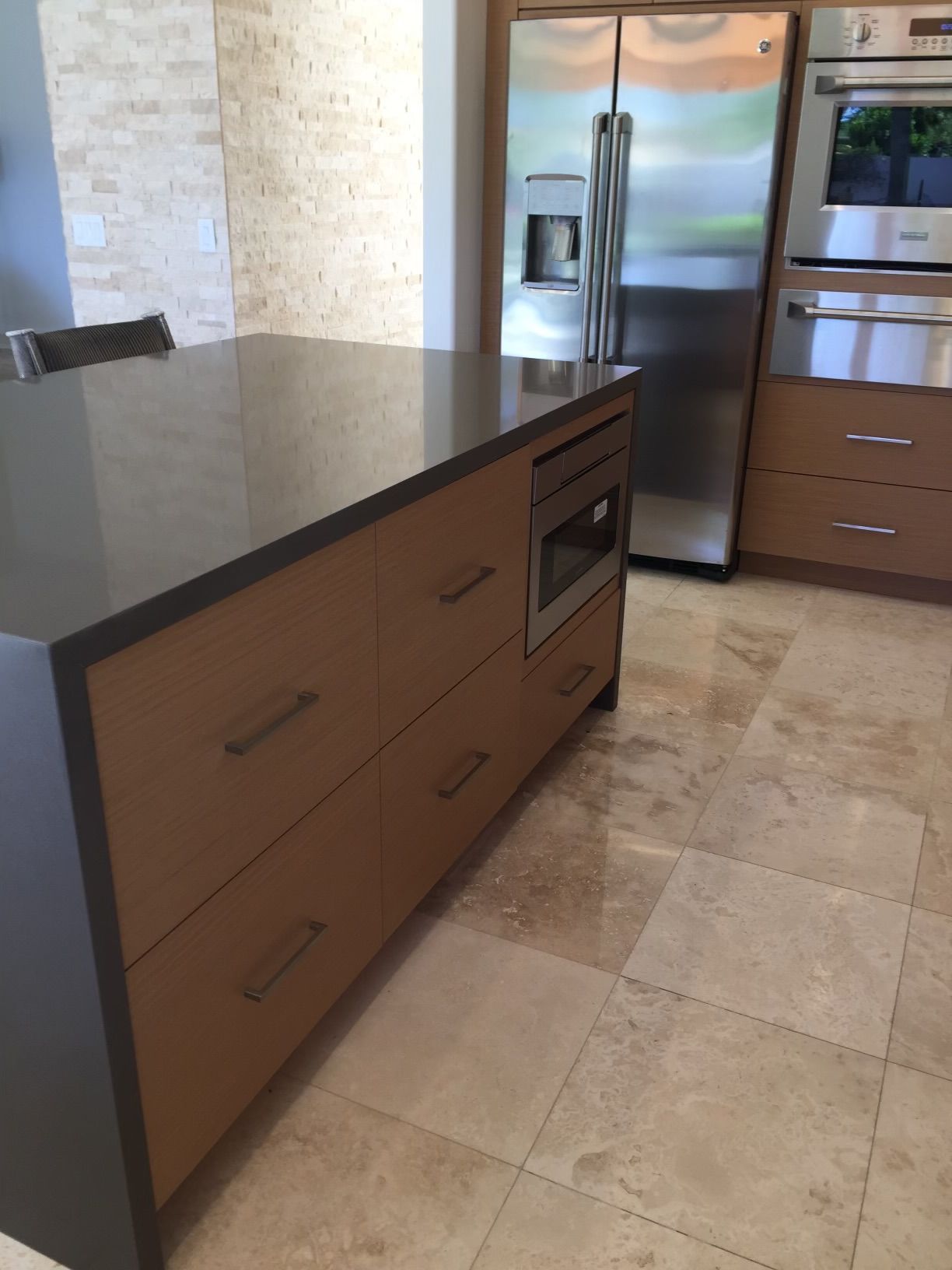 A kitchen with stainless steel appliances and wooden cabinets