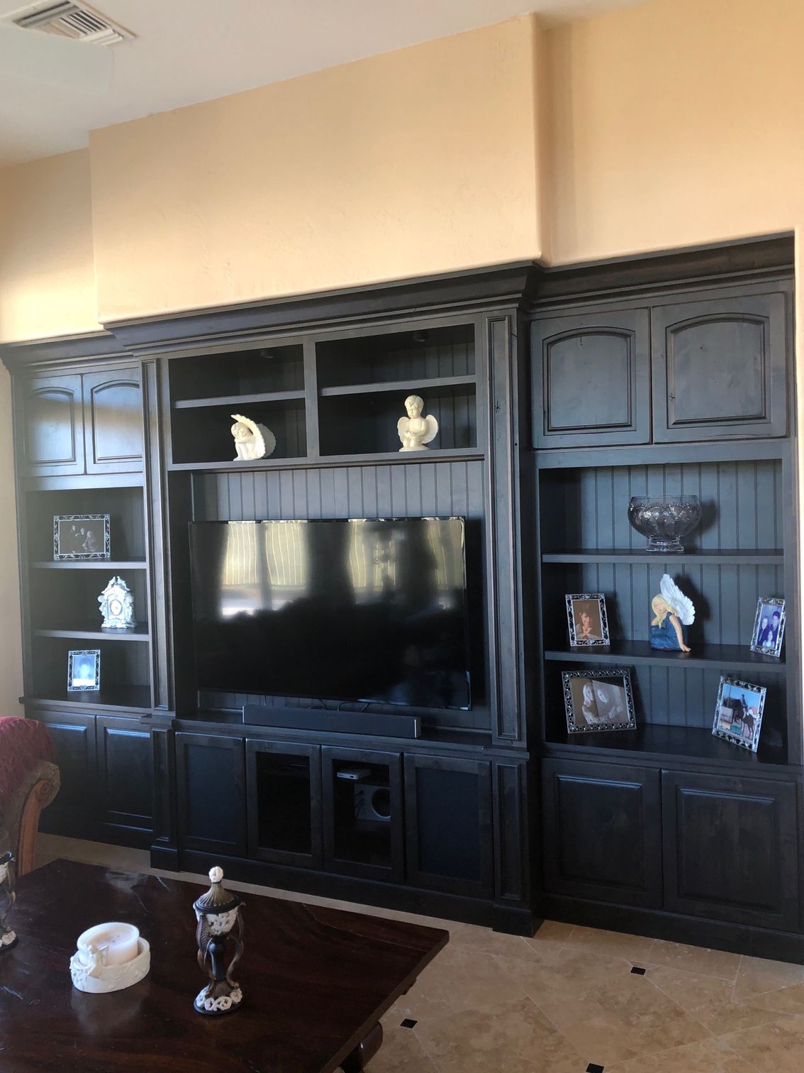 A living room with black cabinets and a flat screen tv