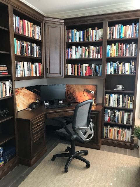 A chair sits in front of a desk in a library