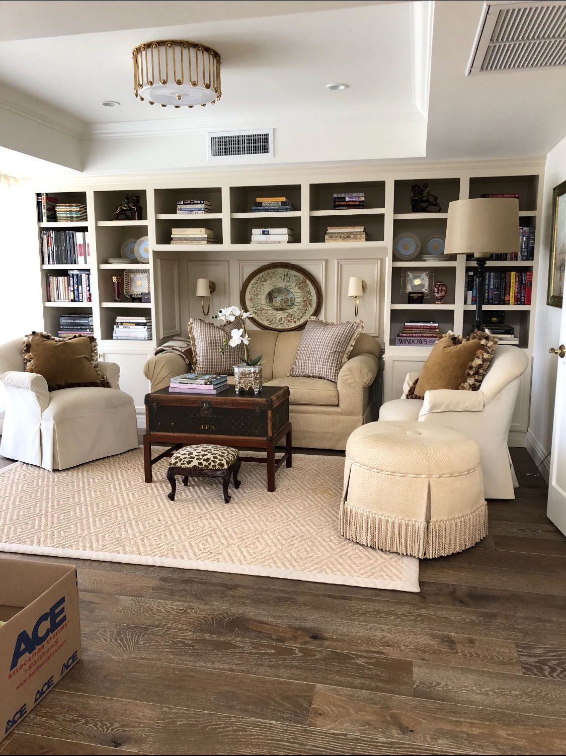 A living room with furniture and a box that says ace on it