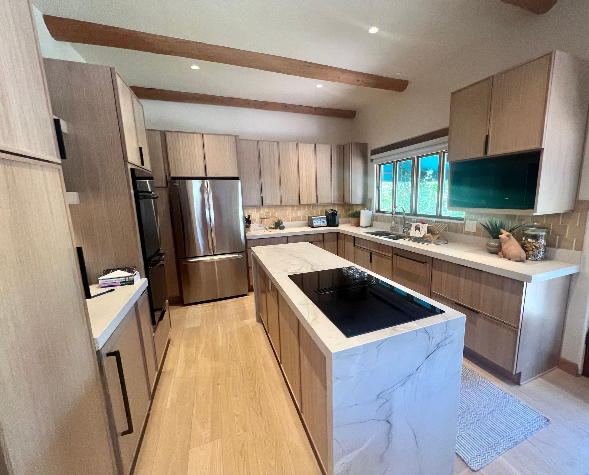 A kitchen with stainless steel appliances and wooden cabinets