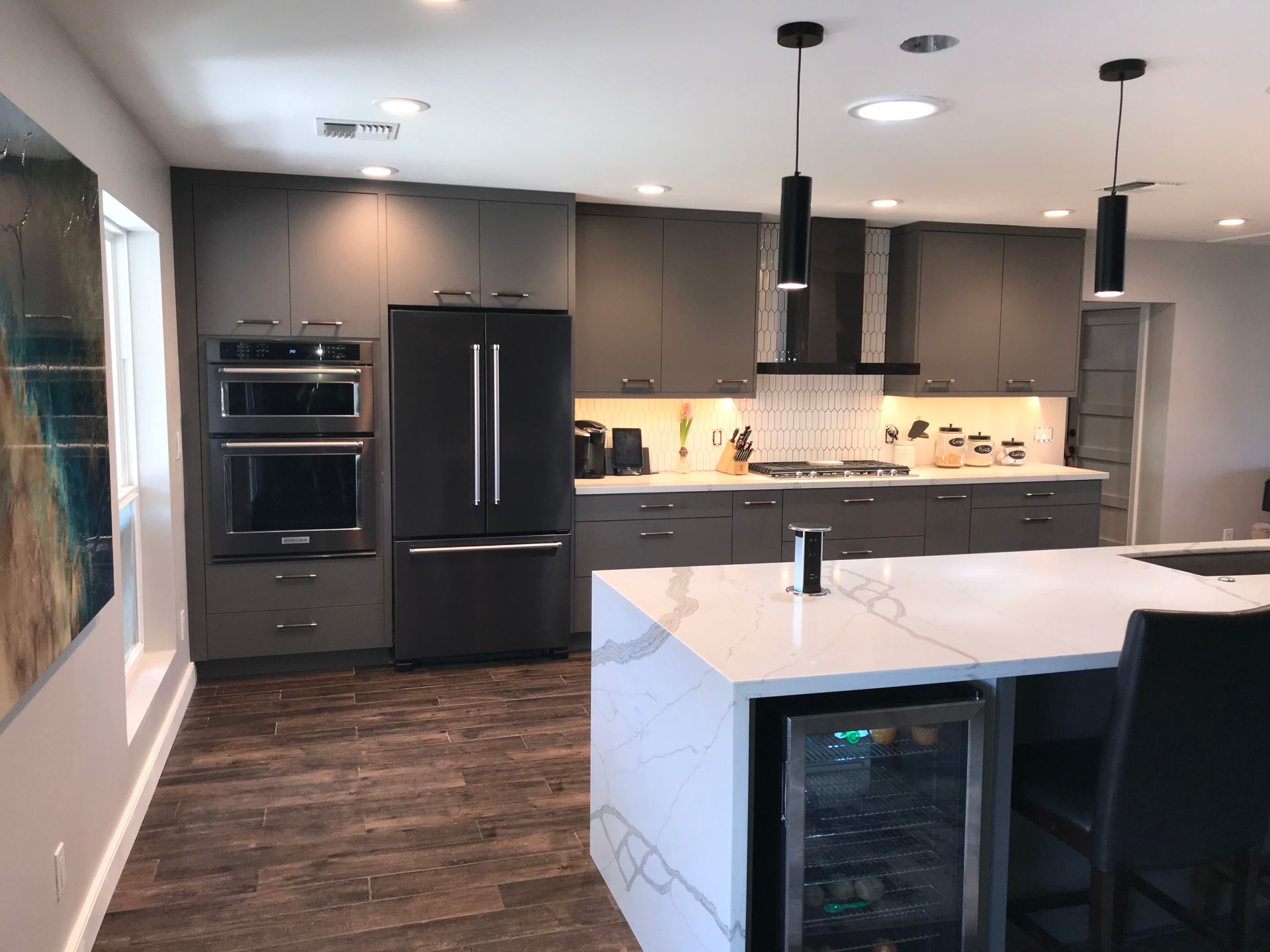 A kitchen with a large island and a refrigerator