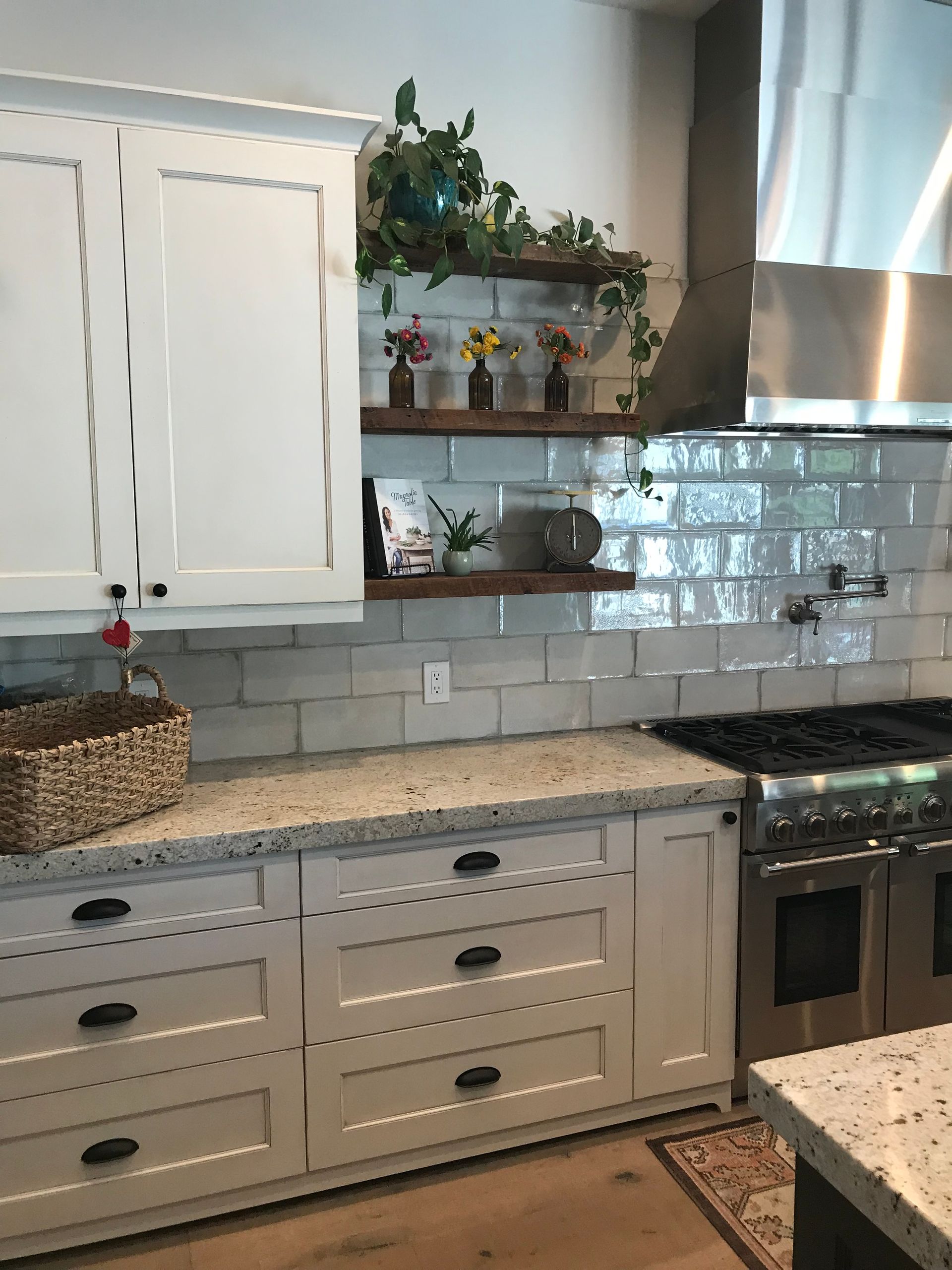 A kitchen with white cabinets and granite counter tops