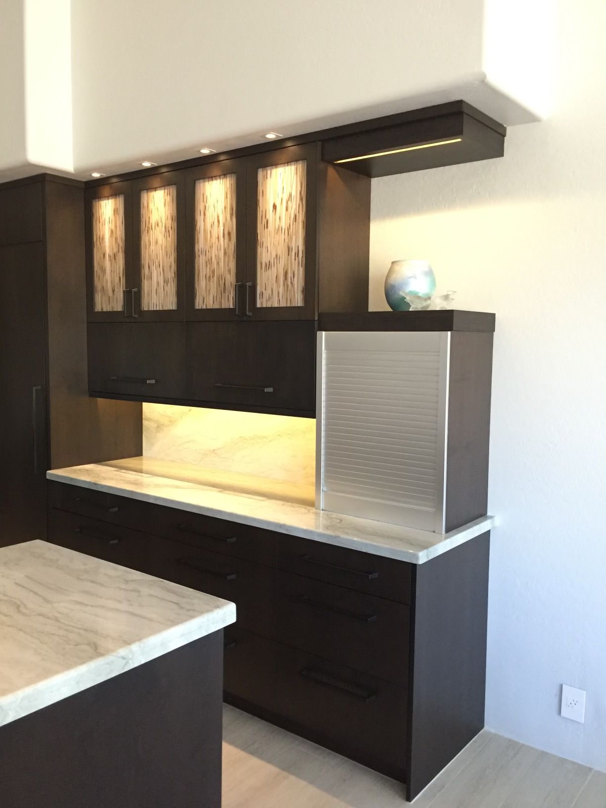 A kitchen with stainless steel appliances and wooden cabinets