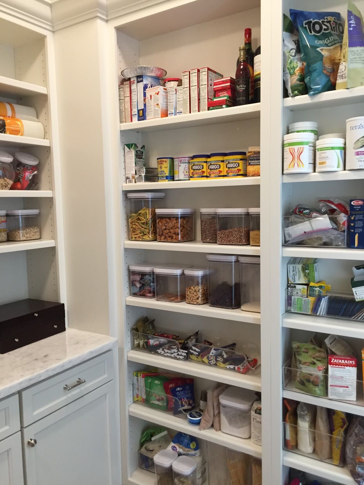 A pantry filled with lots of food and supplies.