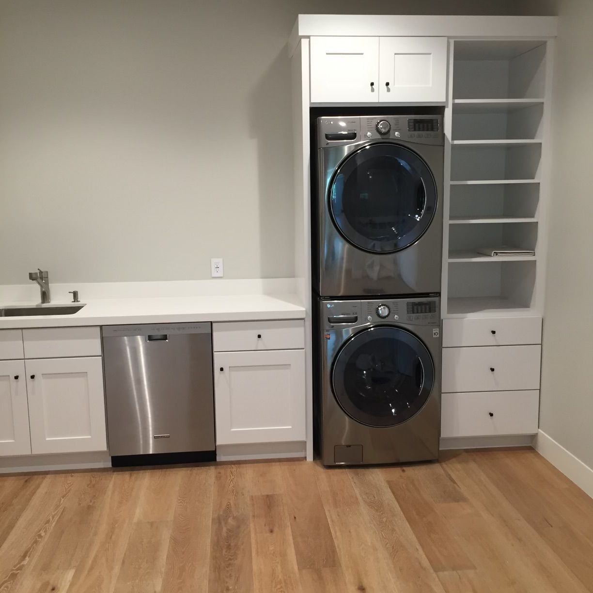 A laundry room with a washer and dryer stacked on top of each other