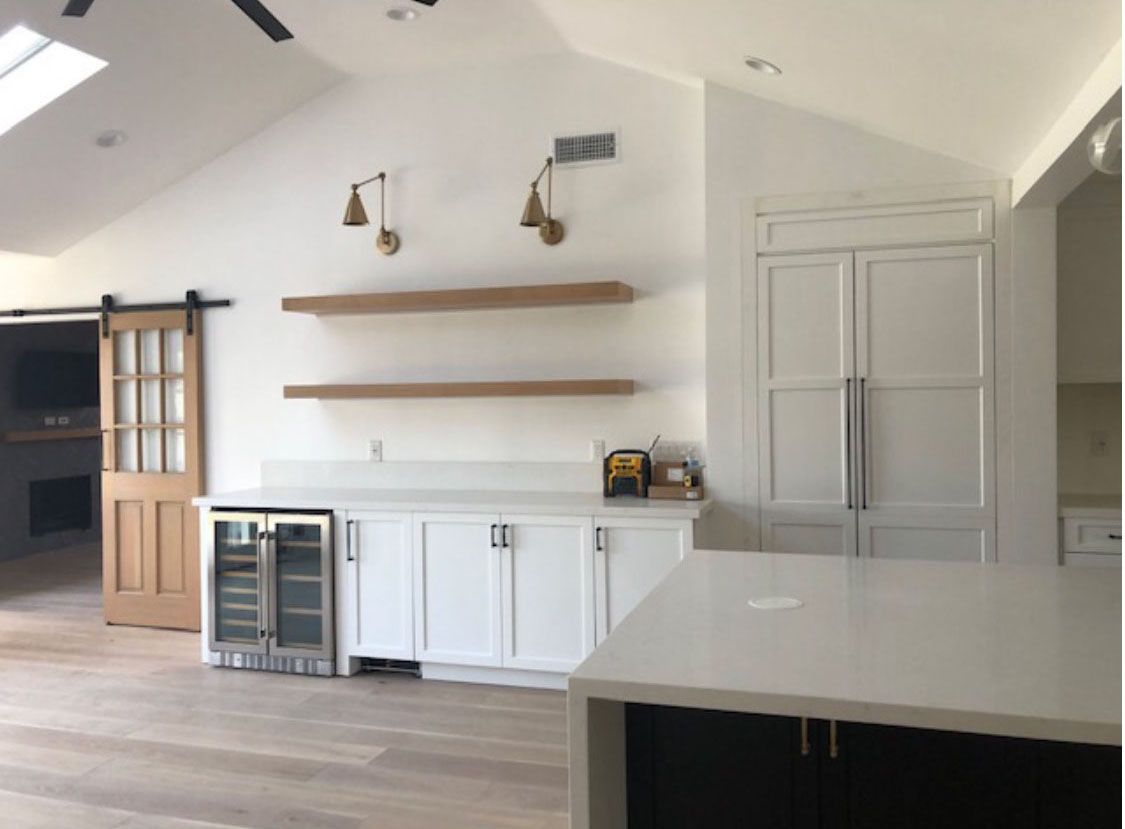 A kitchen with white cabinets and a sliding barn door.