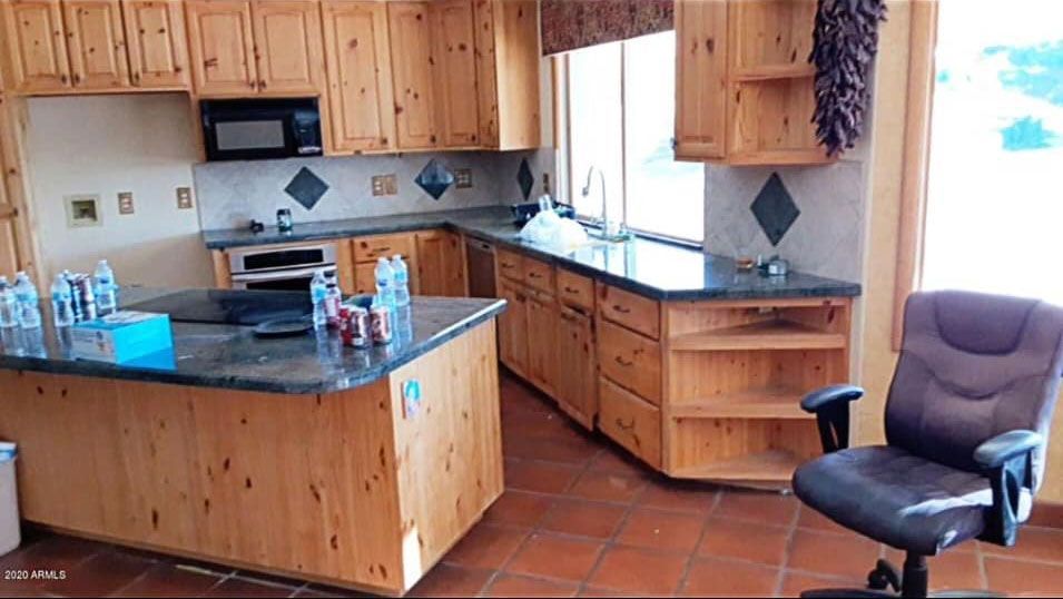 A kitchen with wooden cabinets and granite counter tops