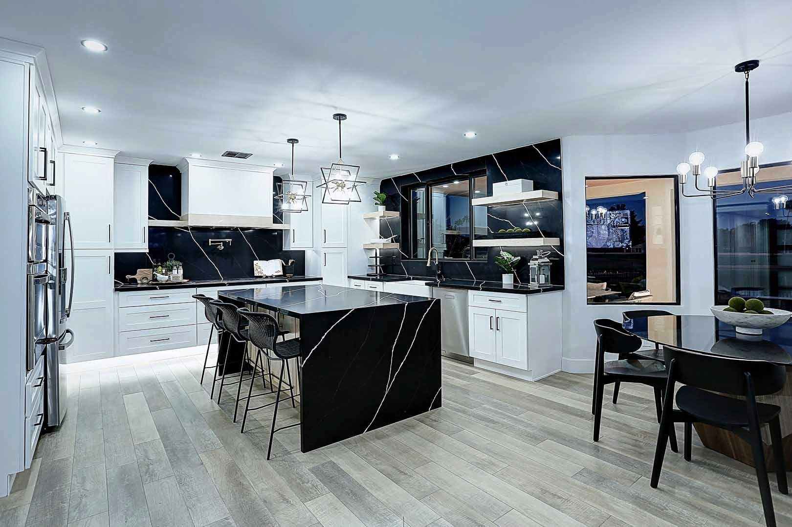 A kitchen with a large island and a dining table.