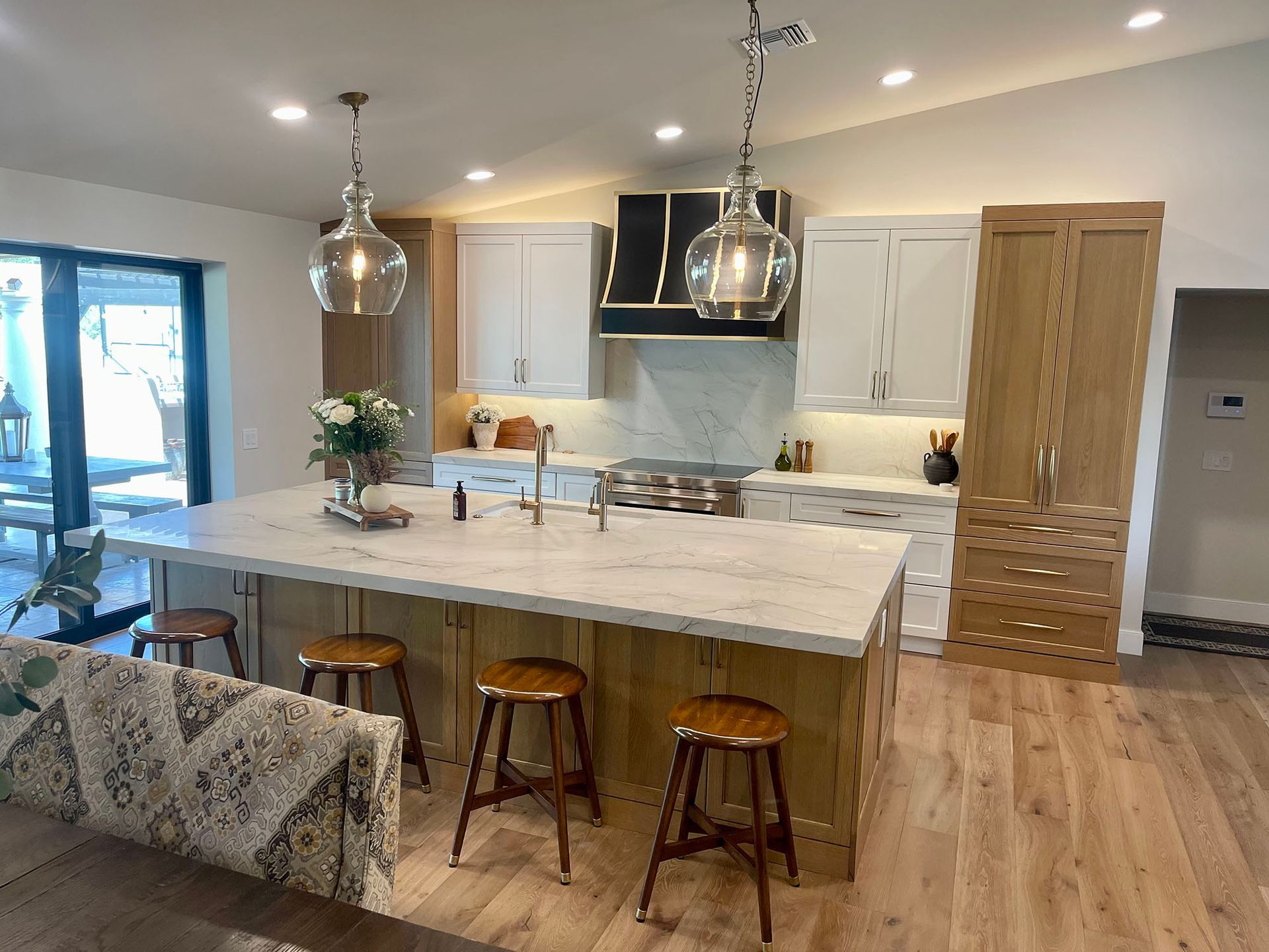 A kitchen with a large island and stools