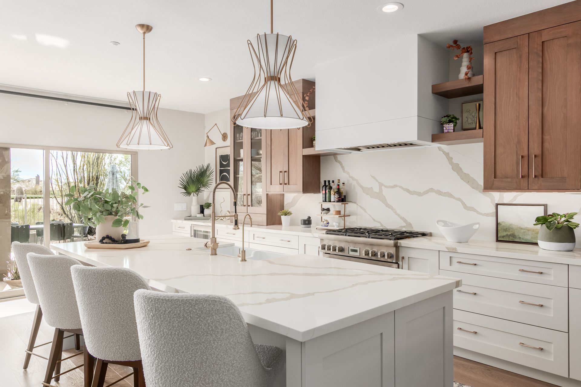 A kitchen with a large island , white cabinets , and wooden cabinets.