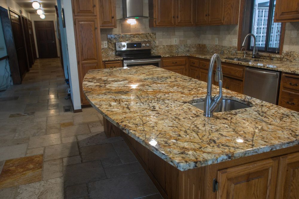 Kitchen with granite countertops, wooden cabinets, and a stainless steel sink.