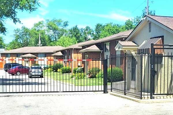 A bedroom with a large bed and a dresser