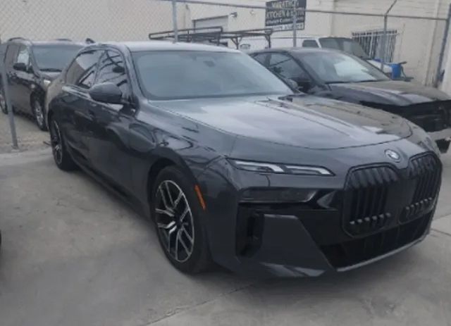 Dark gray BMW sedan parked outside, with a black grille and black rims.