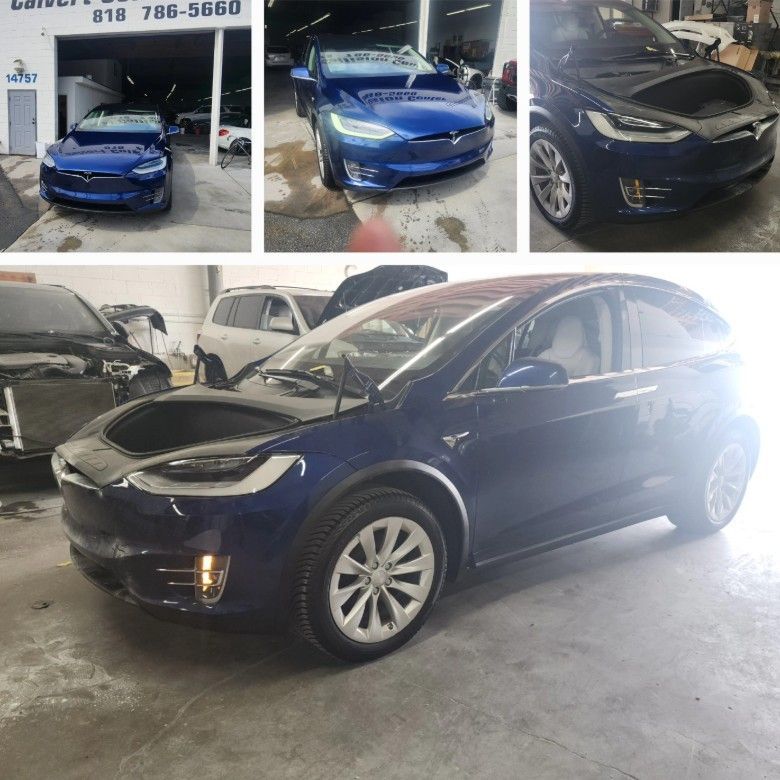 Tesla Model X in blue, different angles in auto repair shop.