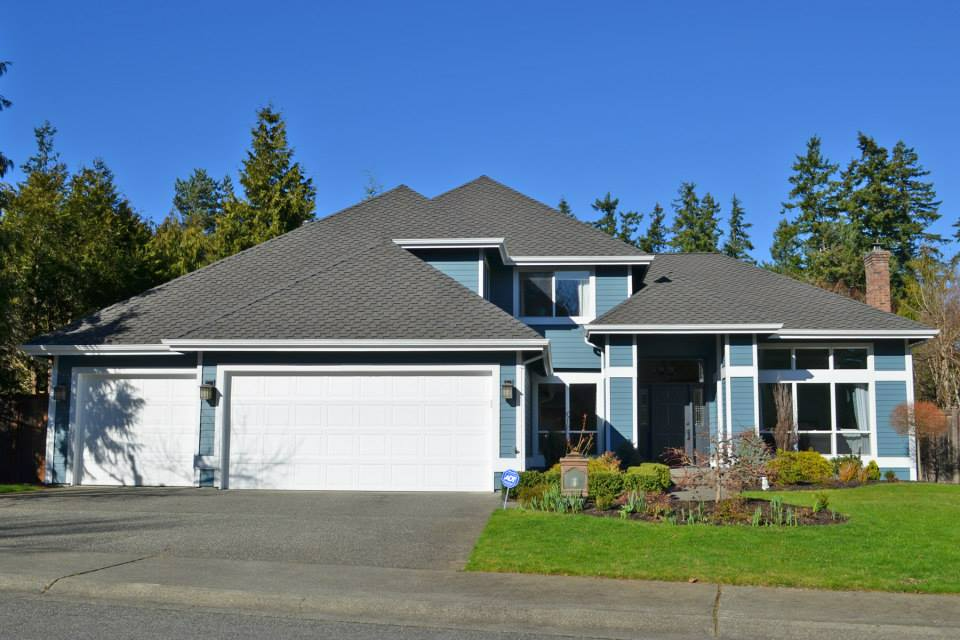 a blue and white house with a gray roof