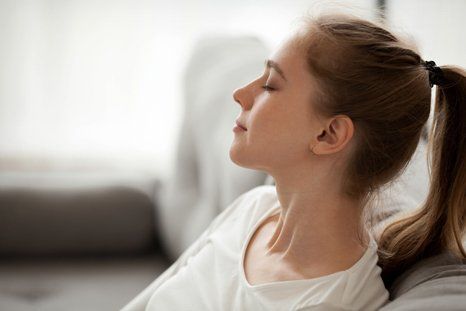 Woman sitting on the couch comfortably