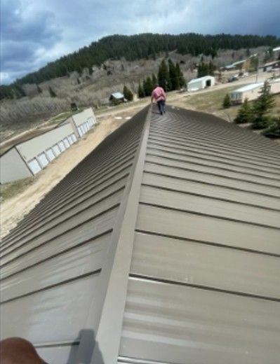 A person is walking up the roof of a building