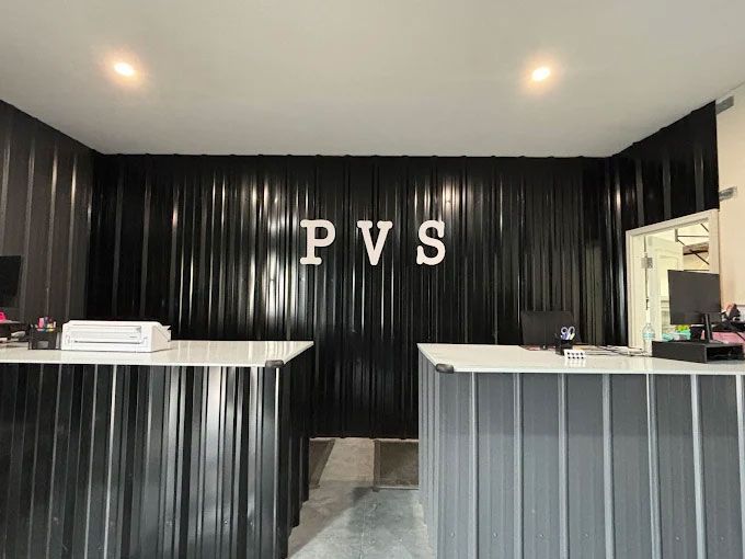 A reception area with two tables and a sign that says pvs.
