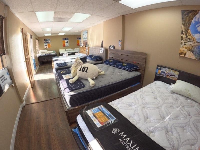 A room filled with mattresses and a stuffed animal with the number 101 on it.