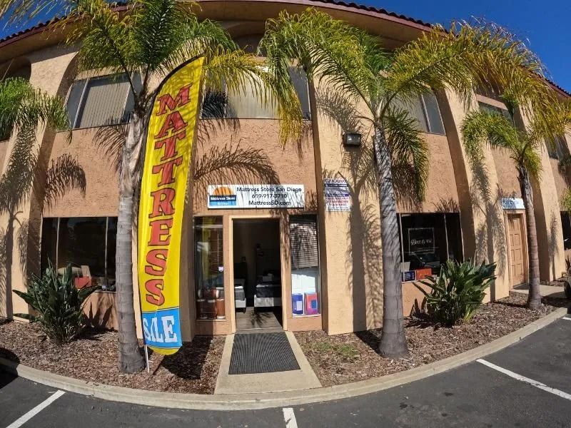 A building with palm trees and a sign that says sale