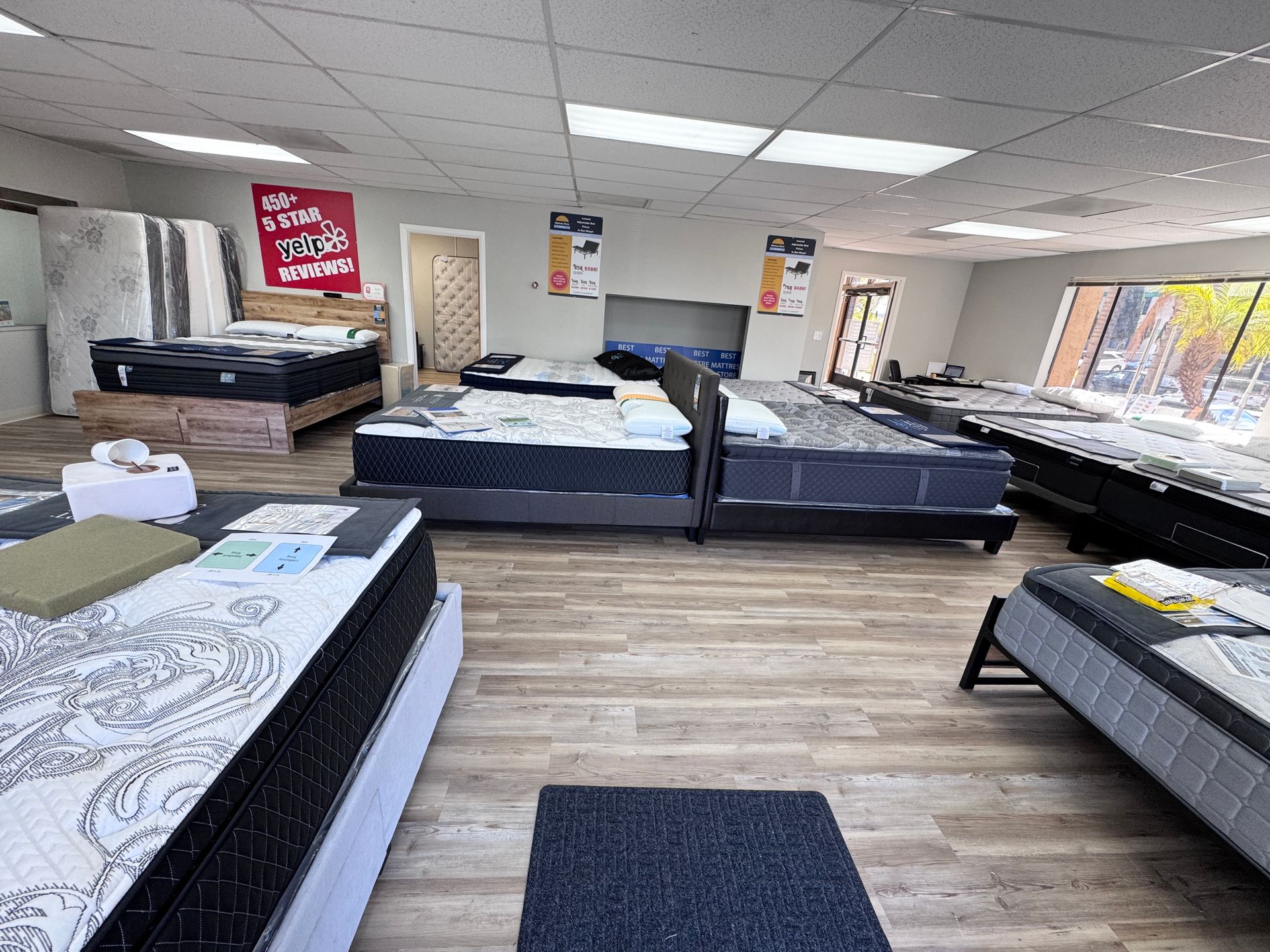 A mattress store filled with lots of beds and mattresses.