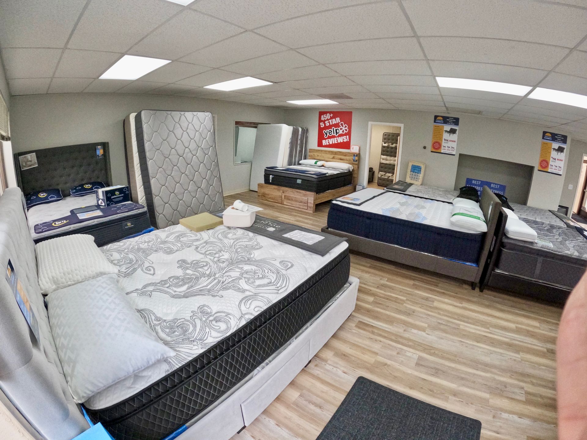 A mattress is sitting on top of a bed on a white background.