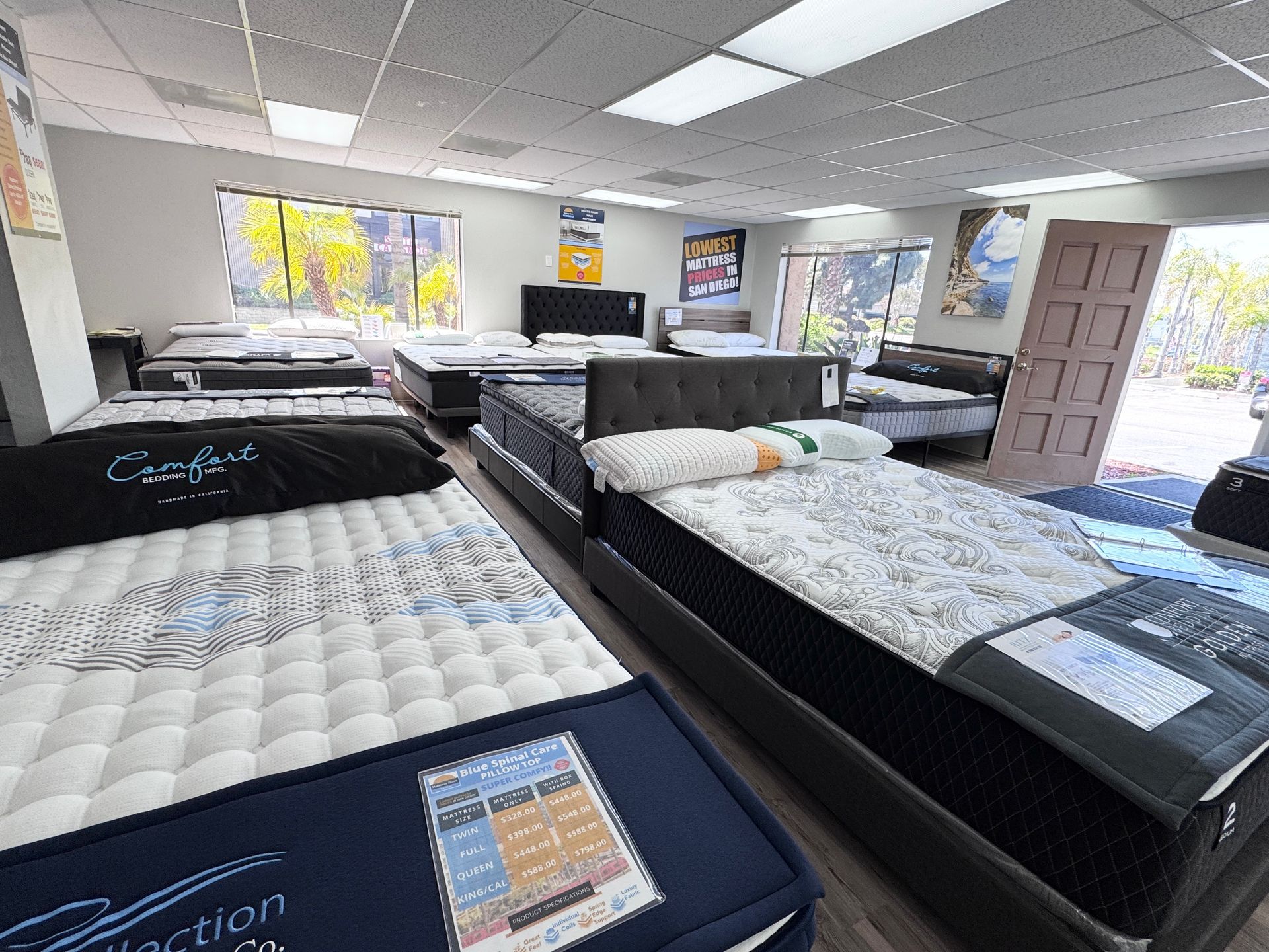A black mattress is sitting on top of a white surface.