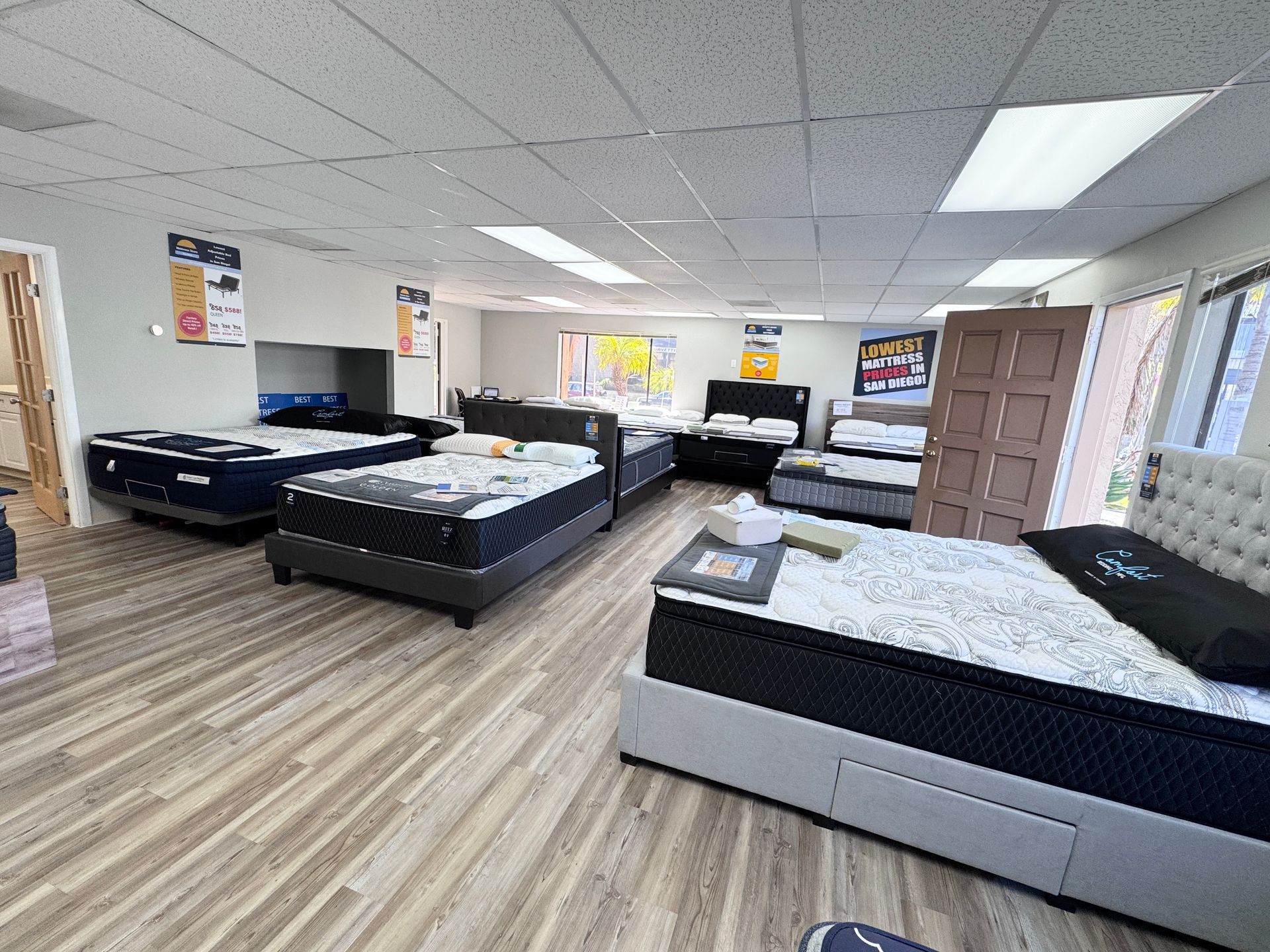 A black mattress is sitting on top of a white surface.