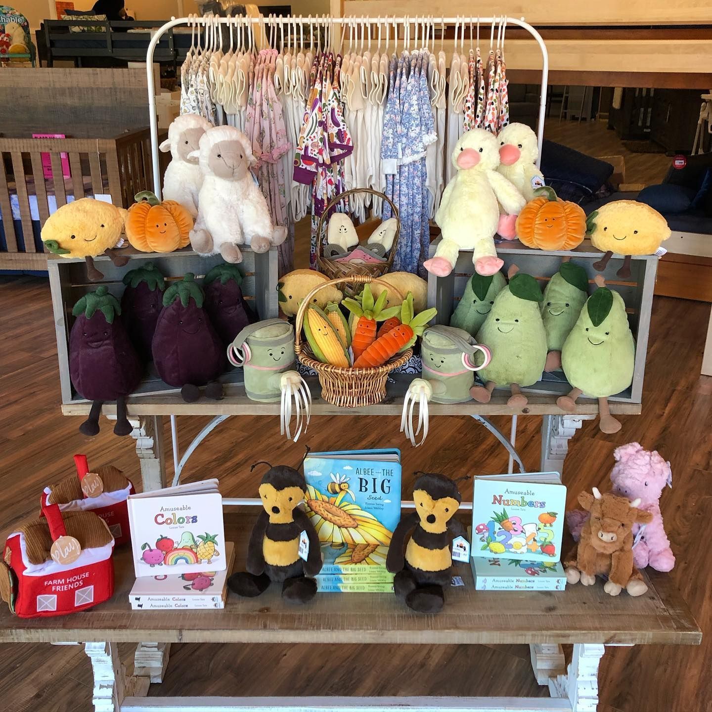 Display of Christmas-themed plush toys, clothes, and decorations in a store setting.