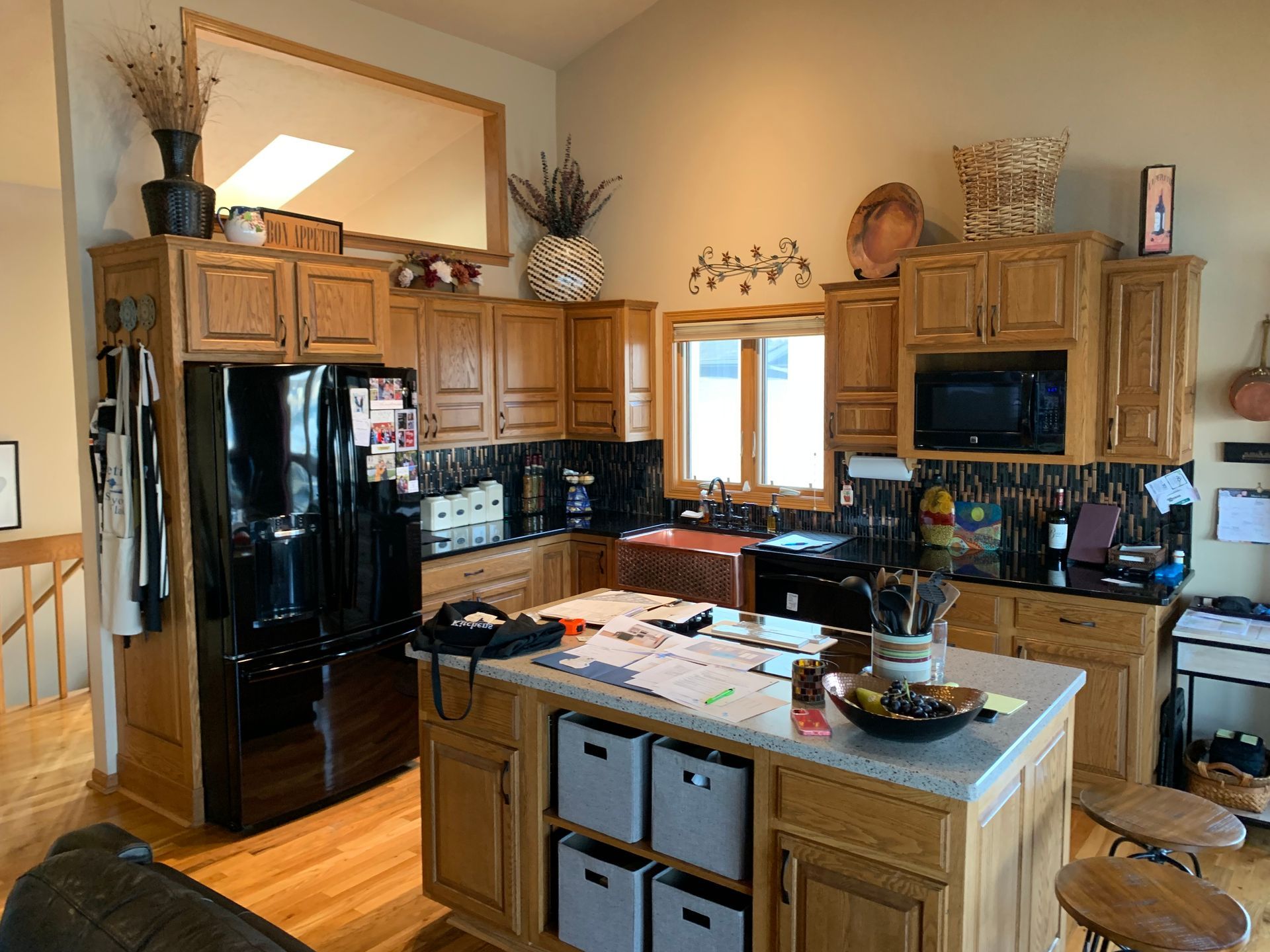 Kitchen with wooden cabinets and a black refrigerator