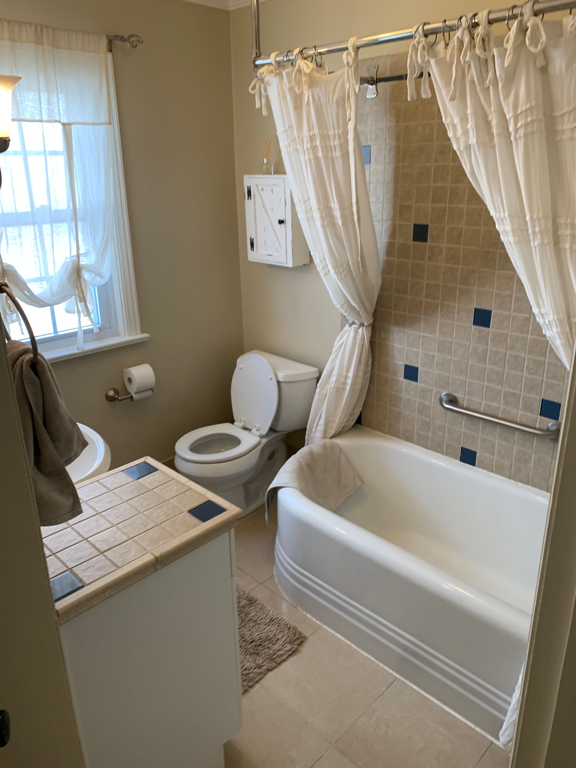 Bathroom with a tub and shower curtain
