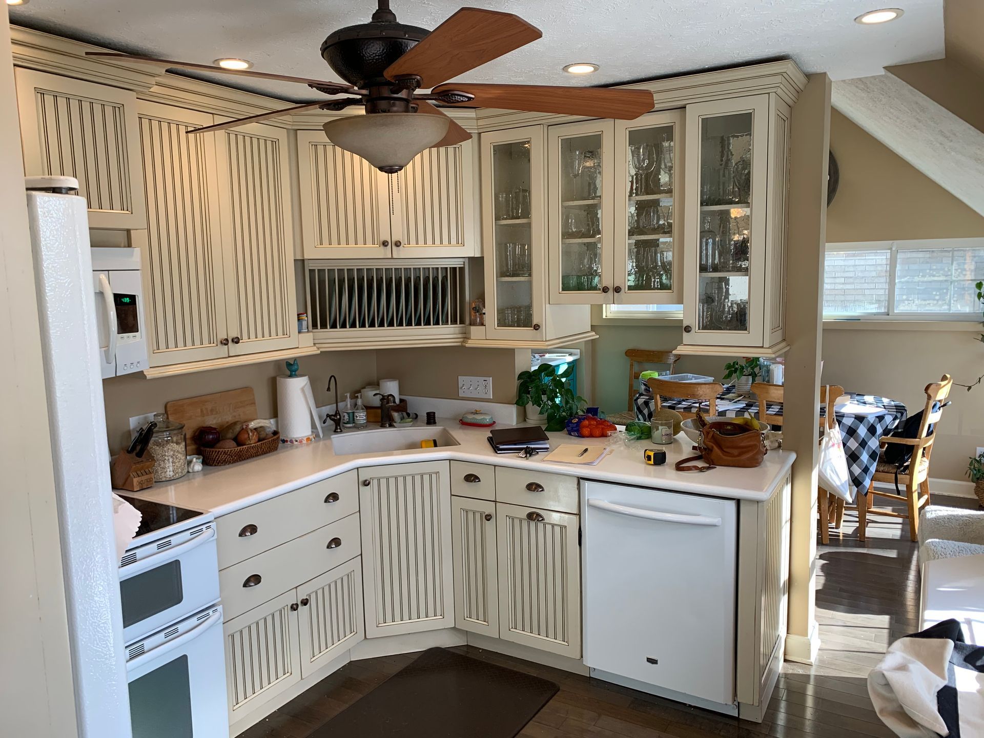 Kitchen with white cabinets and a ceiling fan