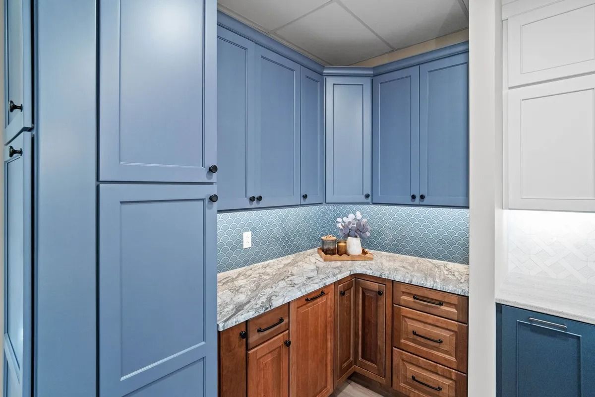 Blue and wood-tone kitchen corner with granite counters and tiled backsplash