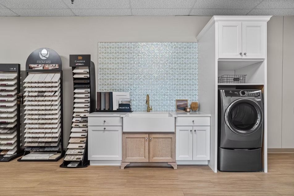 Laundry room with folding tables, stacked supplies, sink, cabinets, and a washer-dryer unit