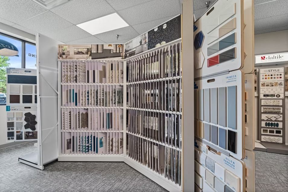 Showroom wall of tile and flooring samples in white display racks
