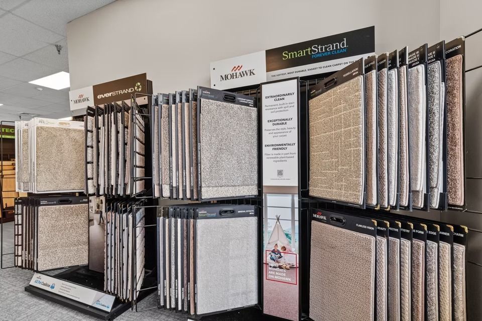 Carpet and flooring sample display racks in a showroom aisle