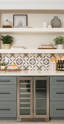 Modern kitchen with gray cabinets, patterned tile backsplash, open shelves, and built-in wine fridge