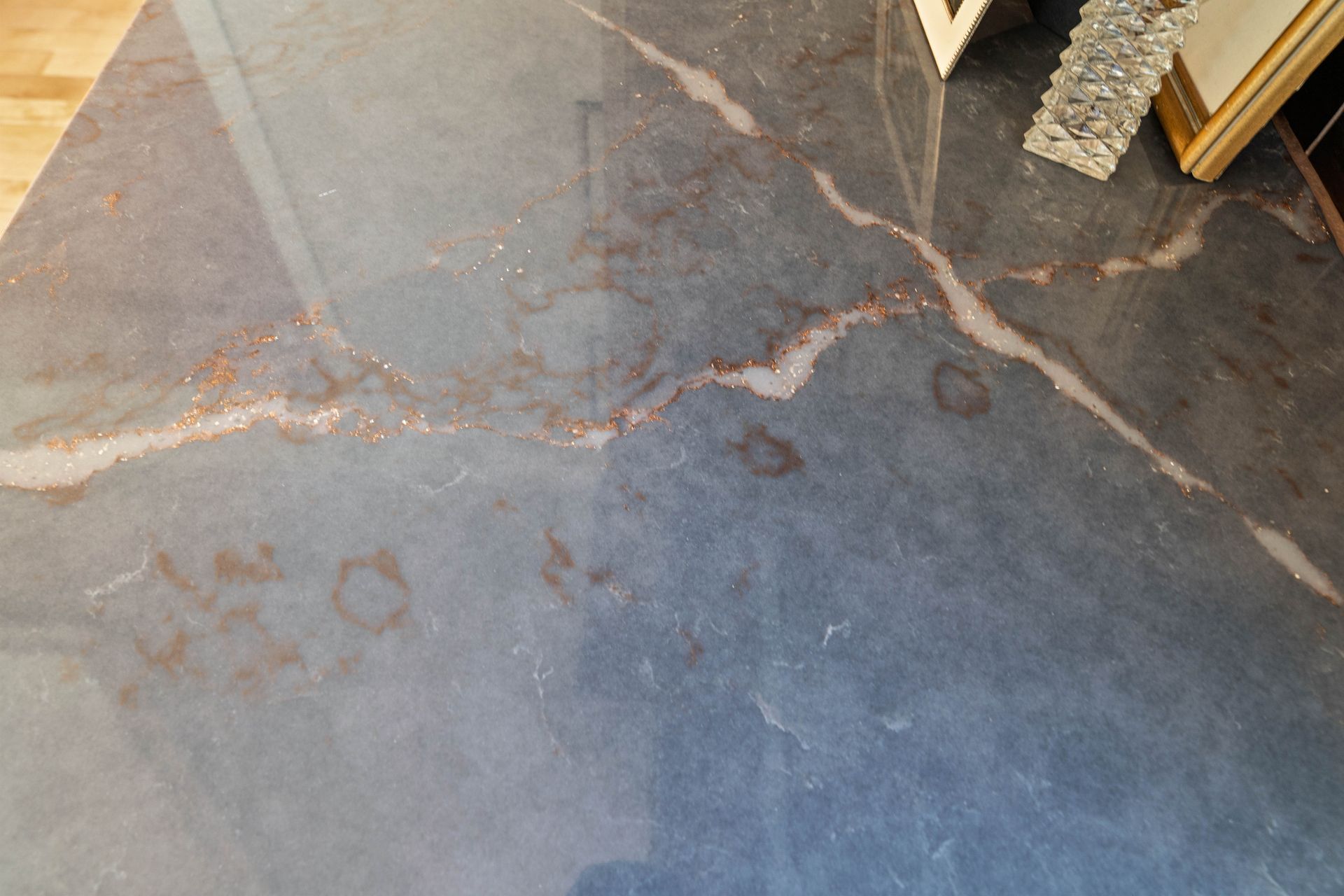 Gray concrete floor with white veining and small brown stains near a doorway