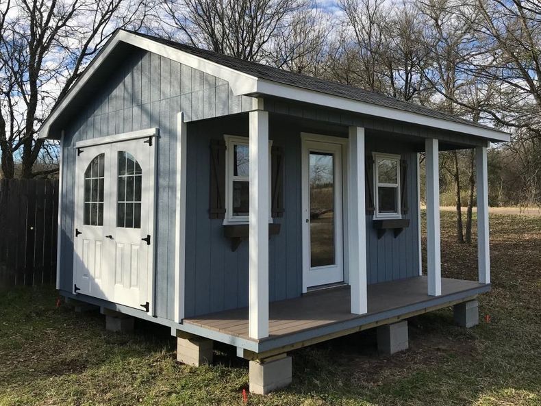 A cottage-style shed with porch