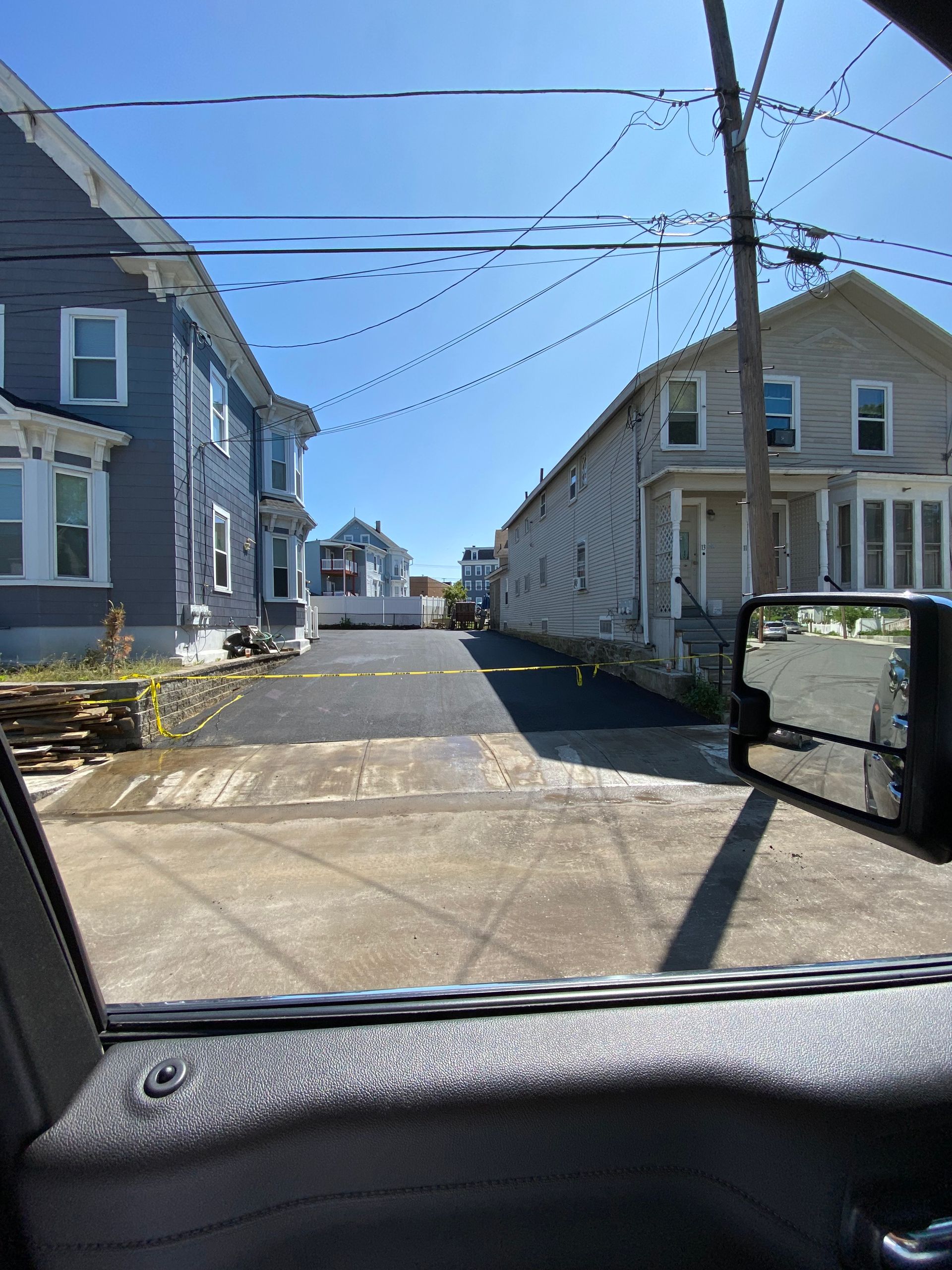 A car is parked in front of a row of houses.